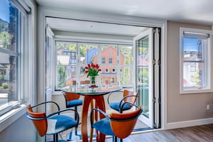 A great spot to play cards at a table with four chairs and mountain and town views.