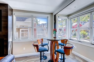A great spot to play cards at a table with four chairs and mountain and town views.