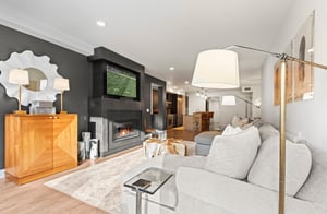 The Rio Grande 203 living room has a large sectional sofa, flat screen TV, and gas burning fireplace.