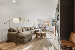 The Rio Grande 203 living room has a large sectional sofa, flat screen TV, and gas burning fireplace.