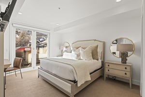 The main suite bedroom with a kingsize bed and lovely views of the town and mountains.