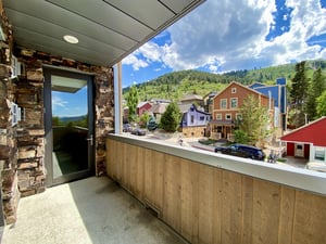 Private patio overlooking Park Avenue and Park City Mountain, colorful historic homes on a sunny summer day