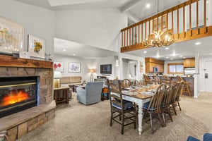 The open concept living, dining, and kitchen area with a gas burning fireplace.