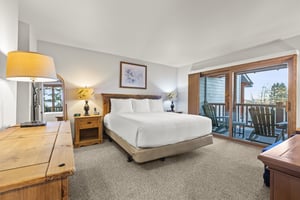 The main suite with a kingsize bed and wood headboard.