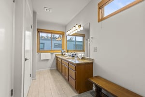 The bathroom with double sink vanity.