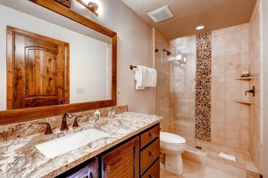 The main suite has an en suite bathroom with one sink vanity and walkin shower.