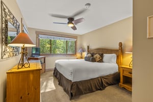 The main suite offers a kingsize bed and wooden furniture.