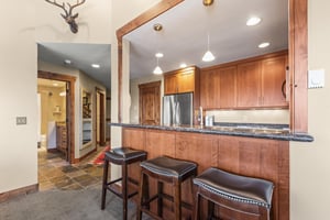 The wellequipped kitchen has a breakfast bar with seating for four guests..