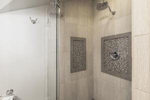 The en suite bathroom offers a walkin shower with beautiful tile.