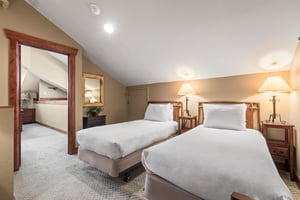 The loft offers two twin beds and leads to another bedroom and bathroom.