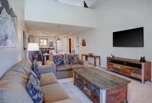 The living room has a comfortable couch and loveseat.