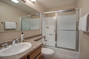 The shared bathroom has a bathtub and shower combination.