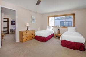 The loft has two twin beds and wood furniture.