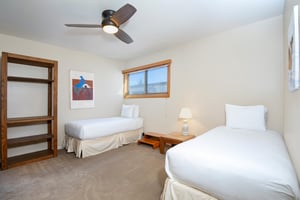 The bedroom, accessed through the loft, has two twin beds.