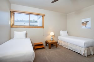 The bedroom, accessed through the loft, has two twin beds.