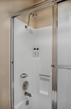 The loft bathroom has a bathtub and shower combination