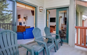 The private deck has four chairs and a small table.