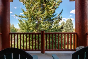 The private deck has views of the mountain and beautiful trees.