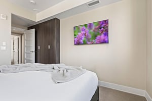 The main suite with a king size bed and flat screen TV.