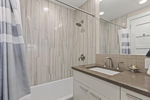 Bathroom two with a bathtub and shower combination.