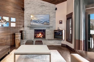 The living area with flatscreen TV, comfortable furniture, and cozy fireplace.