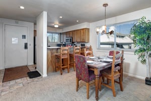 The dining area with seating for four and breakfast bar with seating for three.