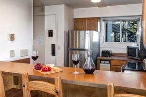 The wellequipped kitchen offers a breakfast bar and stainless steel appliances.
