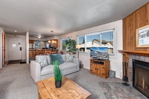 The open concept living room, dining area, and kitchen.