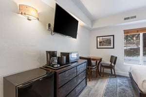 This is a beautiful hotel style room that offers a flat screen TV and sitting area.