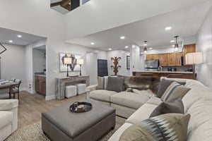 The open concept living room and kitchen area with stylish decor.