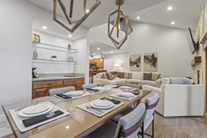 The dining area offers seating for 6 guests and has statement lighting.