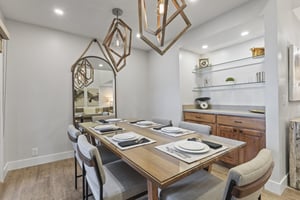 The dining area offers seating for 6 guests and has statement lighting.