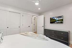 The second bedroom has a king size bed and flat screen TV.
