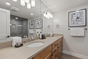 The shared bathroom offers a double sink vanity and walkin shower.