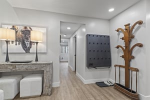 The entry with coat and glove holder and wellappointed furniture and decor.