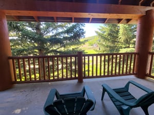 The private deck offers views of the evergreen trees and Park City Mountain Resort.