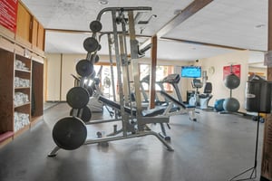 Fitness Room includes various machines and free weights