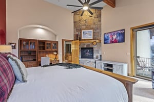 The spacious main suite with a kingsize bed and built in gas fireplace.