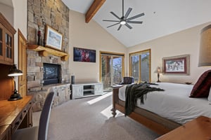 The spacious main suite with a kingsize bed and flat screen TV.