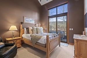 The second bedroom with a queen size bed and access to a private patio with a hot tub.