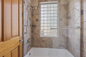 The en suite bathroom with a bathtub and shower combo.