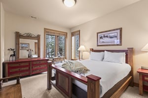 Another bedroom ahs a queen size bed and well appointed furniture.