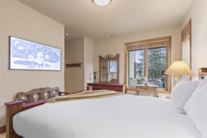 Another bedroom has a queen size bed and flatscreen art TV.