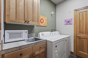The laundry room has a private washer and dryer and utility sink.