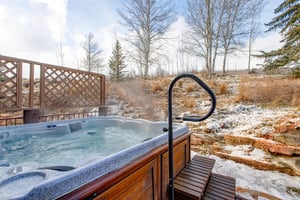 A private hot tub with serene views of the hillside.