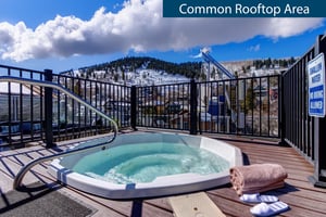 Rio Grandes Rooftop hot tub with lush green mountain views.