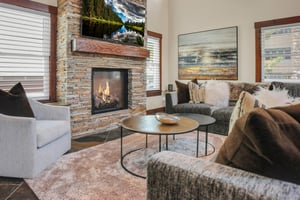 The Peak at Town Lifts living room with a cozy gas burning fire place.
