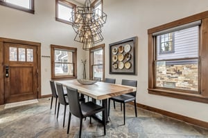 Dining room with spectacular geometric chandelier and slate flooring