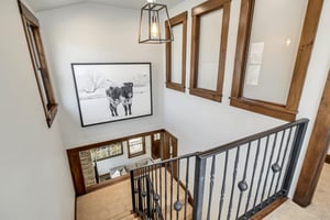 3rd floor hallway with stairway window looking down on the living and dining area