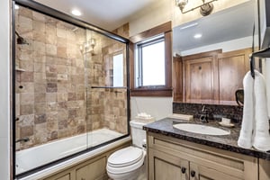 Guest full bathroom with sliding glass panel door